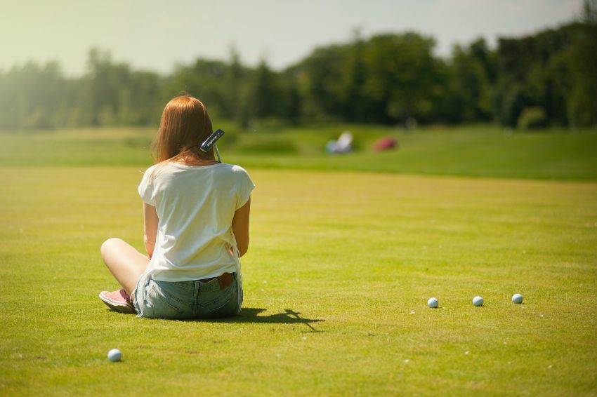 lady sitting golf course